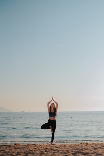 Woman performing a serene yoga pose on a quiet beach